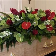Red and green tropical coffin spray 